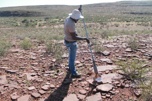 Nabot collecting a soil sample for lab analysis using a soil auger in the Nama Karoo