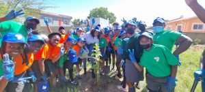 SASSCAL Executive Director Dr Jane Olwoch surrounded by learners from Cimbebasia Primary School Environmental Social Club during the tree planting events